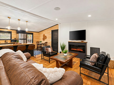 An open, cozy living space with fireplace seating and a full kitchen — ideal for slow mornings and relaxing nights in.