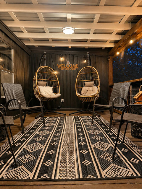 Screened porch for year-round relaxation — Unwind with a book, a drink, or quiet conversation on the covered screened porch overlooking the peaceful ridge setting.