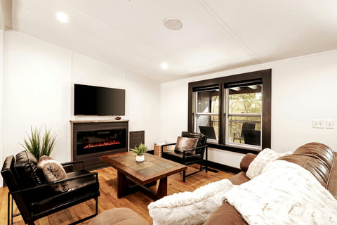 Settle in by the fireplace after a day exploring Blue Ridge, with comfortable seating and room to truly unwind.