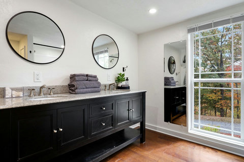 Spacious primary bathroom with double sinks and plenty of room to get ready for your Blue Ridge adventures.