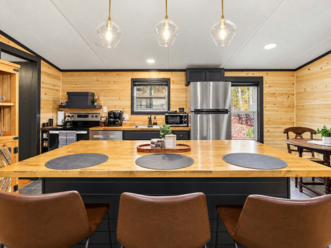 A fully equipped kitchen with island seating makes it easy to cook breakfast, share a meal, or enjoy takeout in comfort.