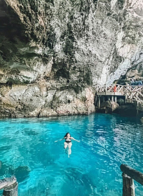 Swim in a crystal-clear cave pool with boardwalk access—pure magic.