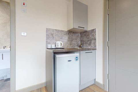 Convenient kitchenette equipped with a fridge, kettle, mugs, and cutlery, along with tea and coffee making facilities—perfect for a quick breakfast or a cozy cup to start or end your day.