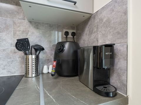 Utilize the fully equipped communal kitchen, which includes a microwave, kettle, toaster, air fryer, and coffee maker, along with plenty of crockery and cutlery—perfect for creating memorable meals and snacks during your visit.