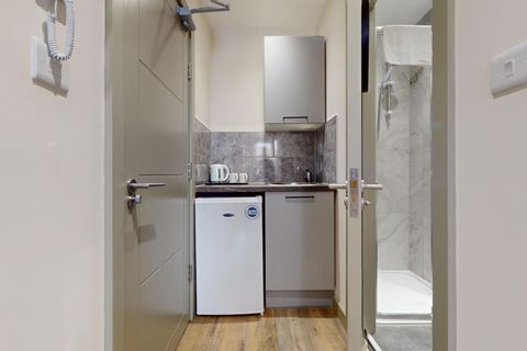 Enjoy the kitchenette with fridge freezer and tea & coffee setup, plus a workspace, wardrobe, hangers, and hair dryer for all the comforts of home.