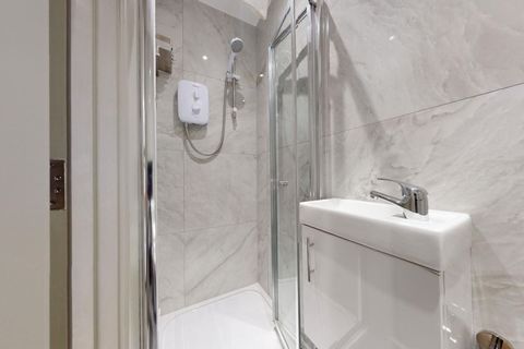 Enter a stylish, modern bathroom outfitted with high-end fixtures, plush towels, and luxury toiletries, including shower gel, shampoo, conditioner, and soap, for a truly refreshing experience. A hair dryer is also available for added ease.
