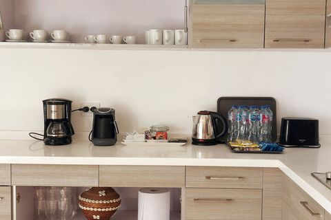 Full equipped shared kitchen with a front yard access door for a sunny breakfast with coffee
