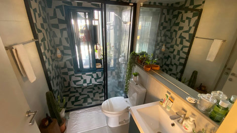 Bathroom with access to small bedroom and common area
