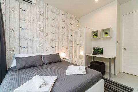 3rd bedroom with queen sized bed, desk, closet and balcony outside.