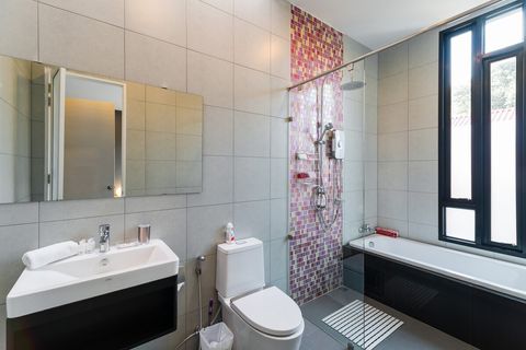 En-suite bathroom with rain shower and bathtub.