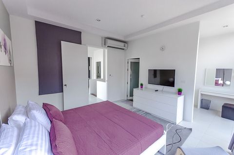 Master bedroom with balcony and private, en-suite bathroom.