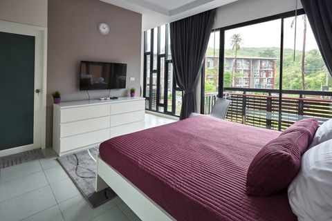 Master bedroom with balcony and private, en-suite bathroom.