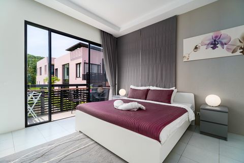 Master bedroom with balcony and private, en-suite bathroom.