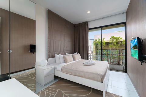 2nd bedroom with king sized bed, desk, large closet and balcony outside.