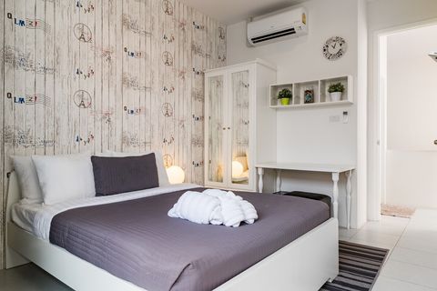 3rd bedroom with queen sized bed, desk, closet and balcony outside.