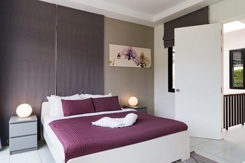 Master bedroom with balcony and private, en-suite bathroom.