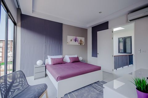 Master bedroom with balcony and private, en-suite bathroom.