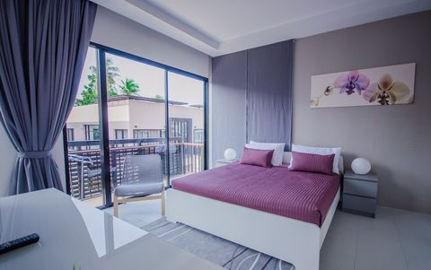 Master bedroom with balcony and private, en-suite bathroom.