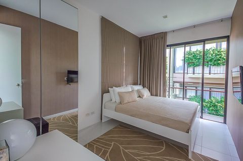 2nd bedroom with king sized bed, desk, large closet and balcony outside.