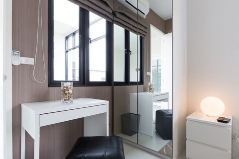 2nd bedroom with king sized bed, desk, large closet and balcony outside.