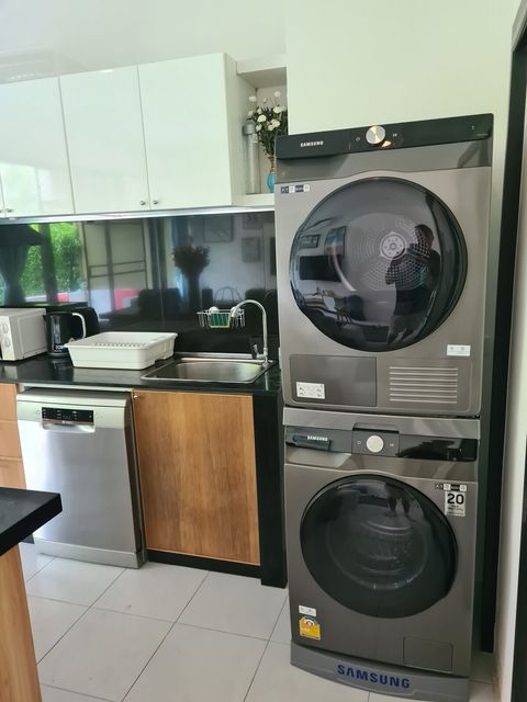 There is a washing machine and dryer in the kitchen
