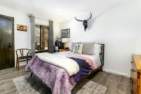 This is a lock-off unit/bedroom with it's own entrance, bathroom, 32in TV, dresser + vanity and a walk-in closet. The picture is taken with a wide-angle lens, so the room may appear a bit smaller in person.