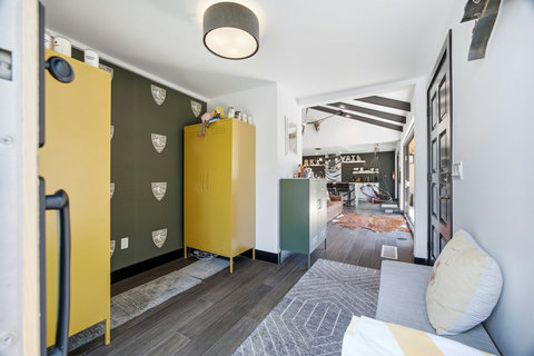 Bright designer entryway with bold storage and open-concept living beyond