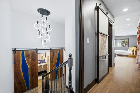 Stylish hallway with designer lighting and artisan sliding doors
