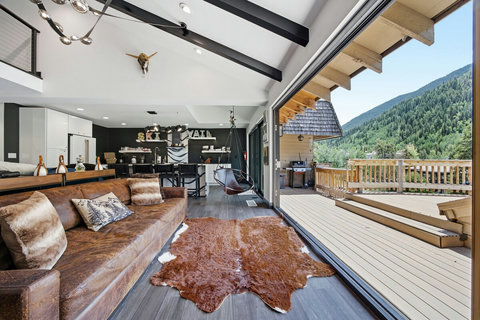 Open-concept mountain retreat with expansive deck and scenic views