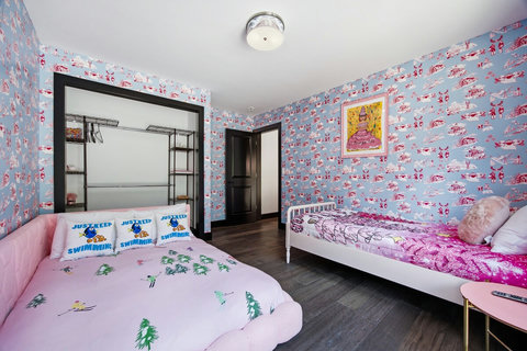 Playful family-friendly bedroom with two beds and colorful decor