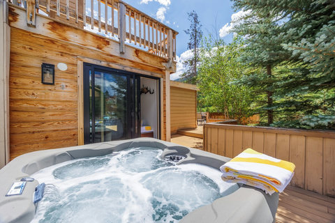 Soak in your private hot tub on a scenic wooded deck!