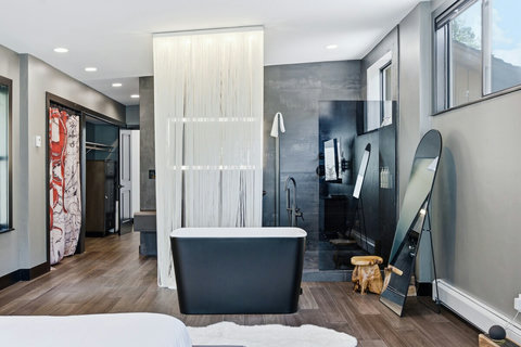 The primary suite tub is right on the bedroom and flows into the exotic style bathroom