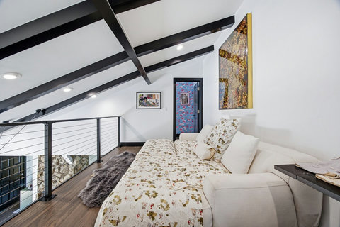 Cozy loft sleeping area with a fun modern design. The loft over-looks the living room