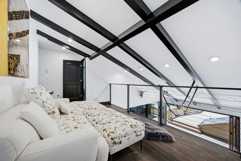 The loft has a cozy sectional couch that is great for a nap, play area or secondary living area. It overlooks the living room