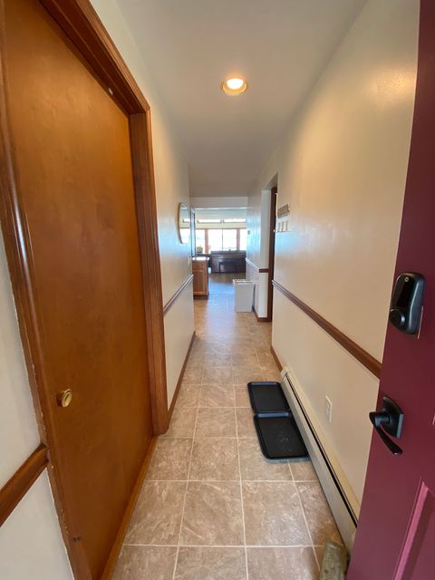 Entry way with laundry to the left and a smart lock for convenience