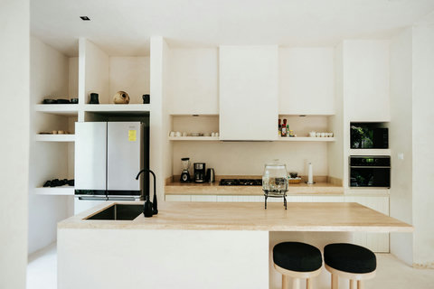 Bright kitchen with island countertop and stools