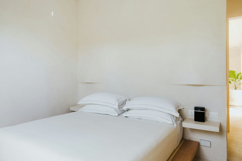 King-size bed dressed in Italian linens for effortless sleep