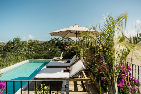 Luxurious terrace with a private pool, overlooking lush greenery and open skies