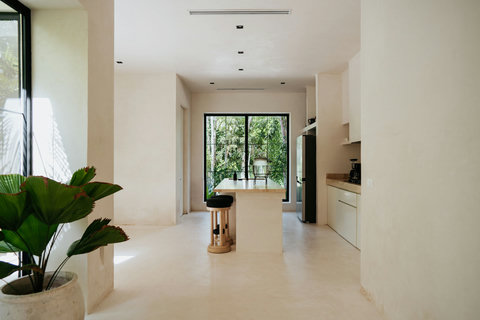 Sleek open kitchen with stone island and scenic garden views