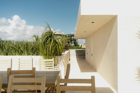 Elegant rooftop dining space with tropical accents and open skies