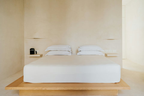 Comfortable platform king-sized bed with a soft, welcoming atmosphere