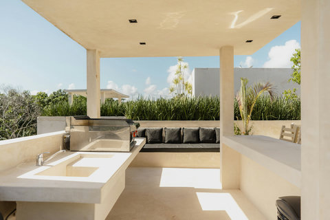 Sun-soaked rooftop with bar, grill, and cozy seating