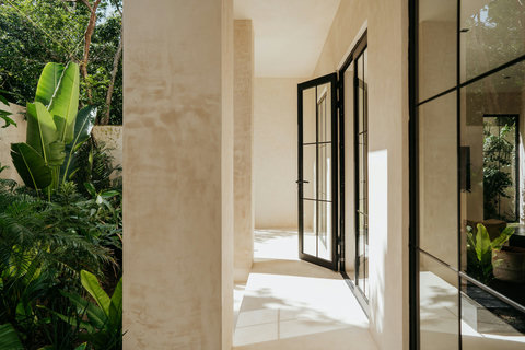 Bright walkway with panoramic glass windows and garden views