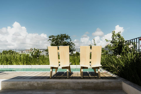 Private pool terrace surrounded by greenery and endless sky