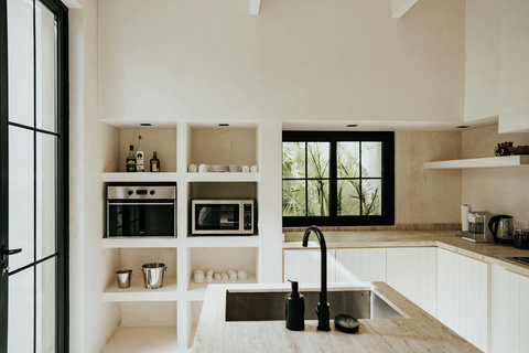 Contemporary kitchen wall featuring countertop oven, microwave, and essentials