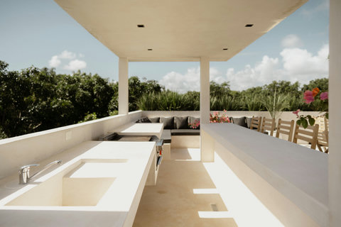 Rooftop lounge with bar stools, grill, and cozy seating