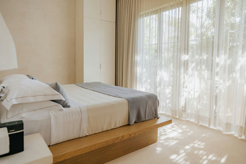 Serene room with a platform king bed overlooking the garden