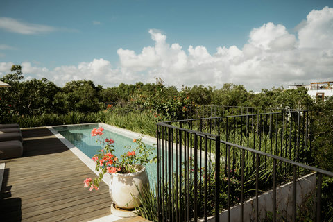 Elevated rooftop terrace with a private pool and serene landscape views