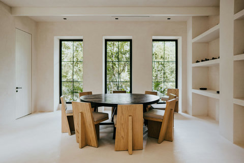 Neutral-toned dining area with natural textures and sunlit windows