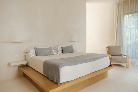 Comfy bedroom with a platform king bed and a cozy reading chair